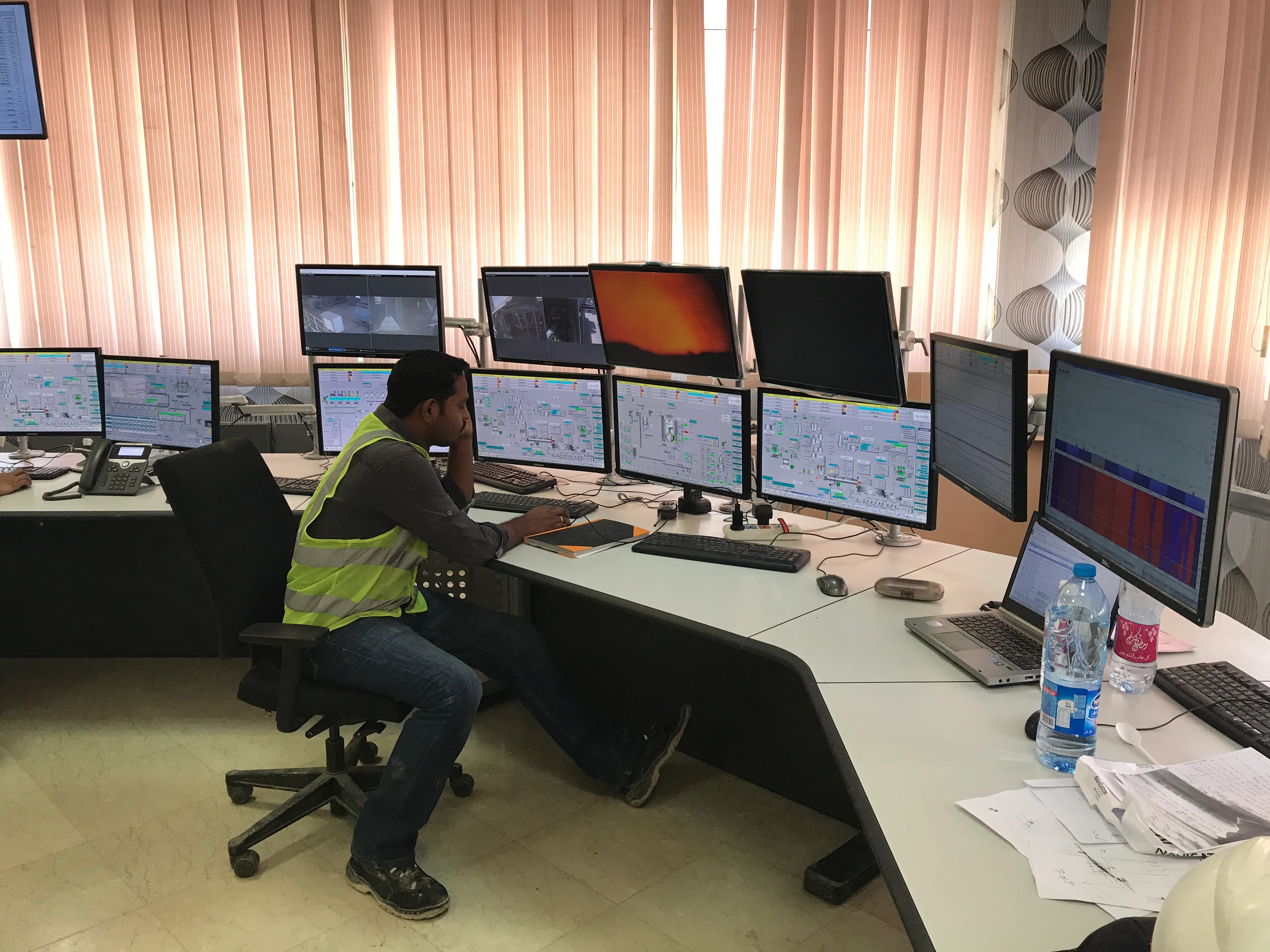 Control room operator at the desk of a cement plant
