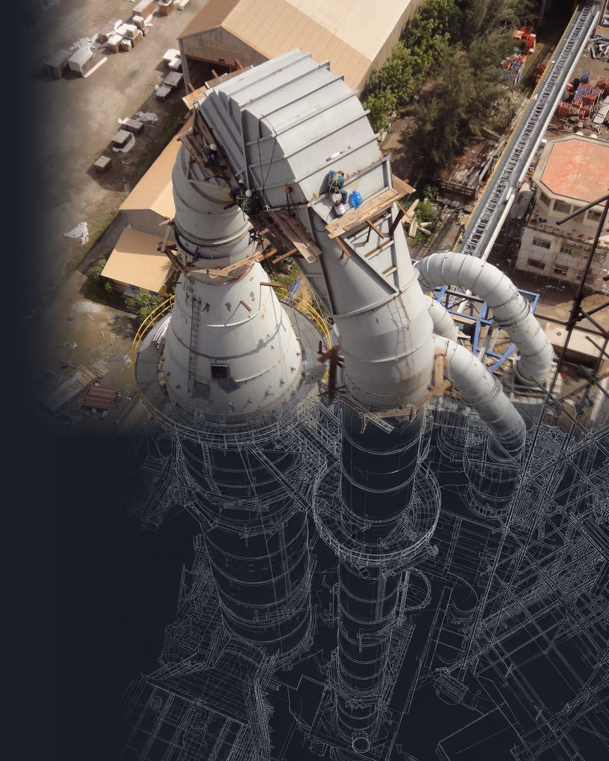 Aerial view of a cement plant preheater dissolving into its engineering wireframe