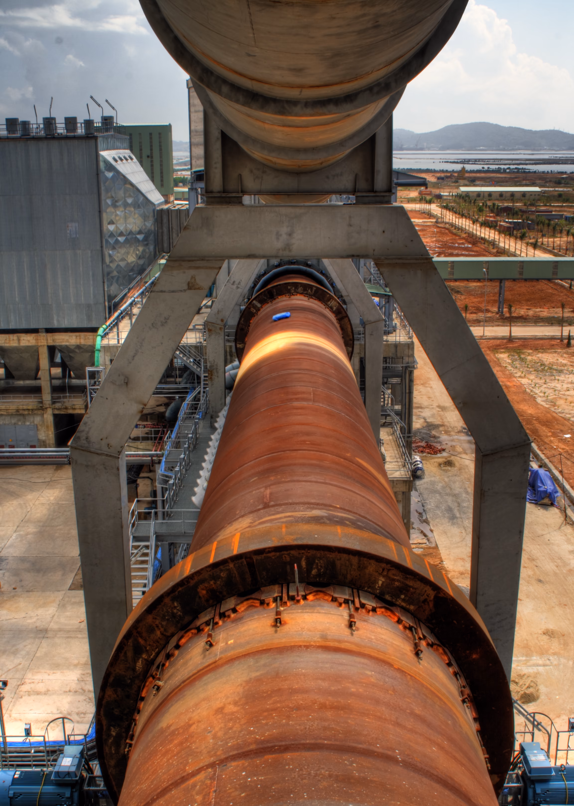 Rotary kiln shell glowing with heat at a cement plant