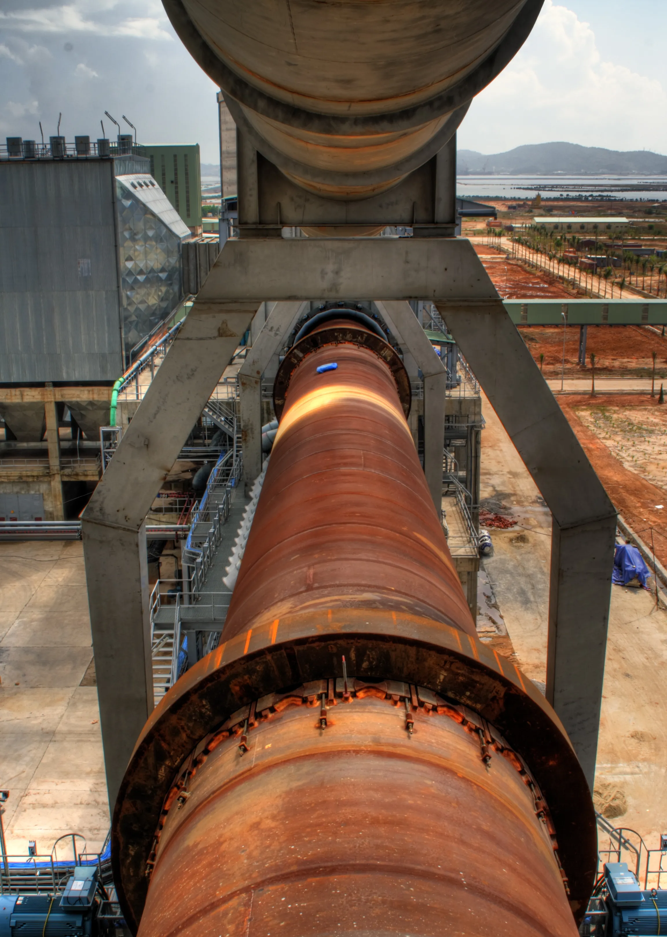 Rotary kiln shell glowing with heat at a cement plant