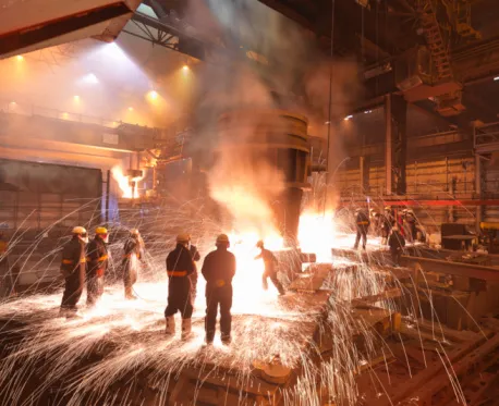 Molten steel tapping with sparks in a steel mill